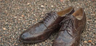Damaged dress shoes before professional restoration